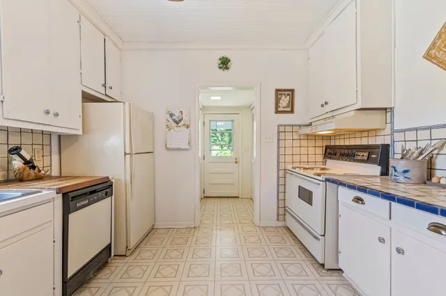 a living room with furniture a rug and a window
