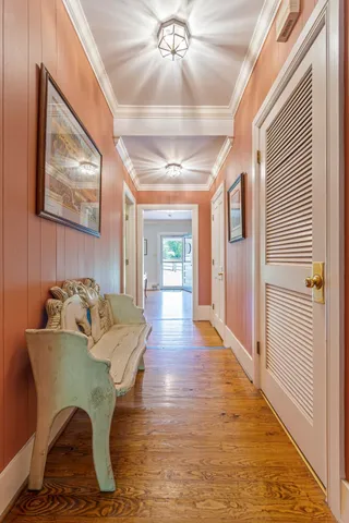 a view of entryway and hall with wooden floor
