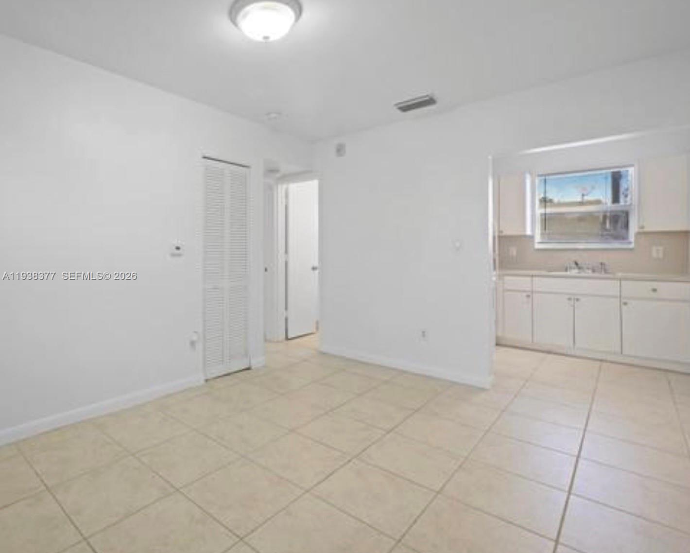 577 Northeast 82nd Street, Unit 14 Miami, FL 33138 - Photo 4 of 11 a view of cabinets