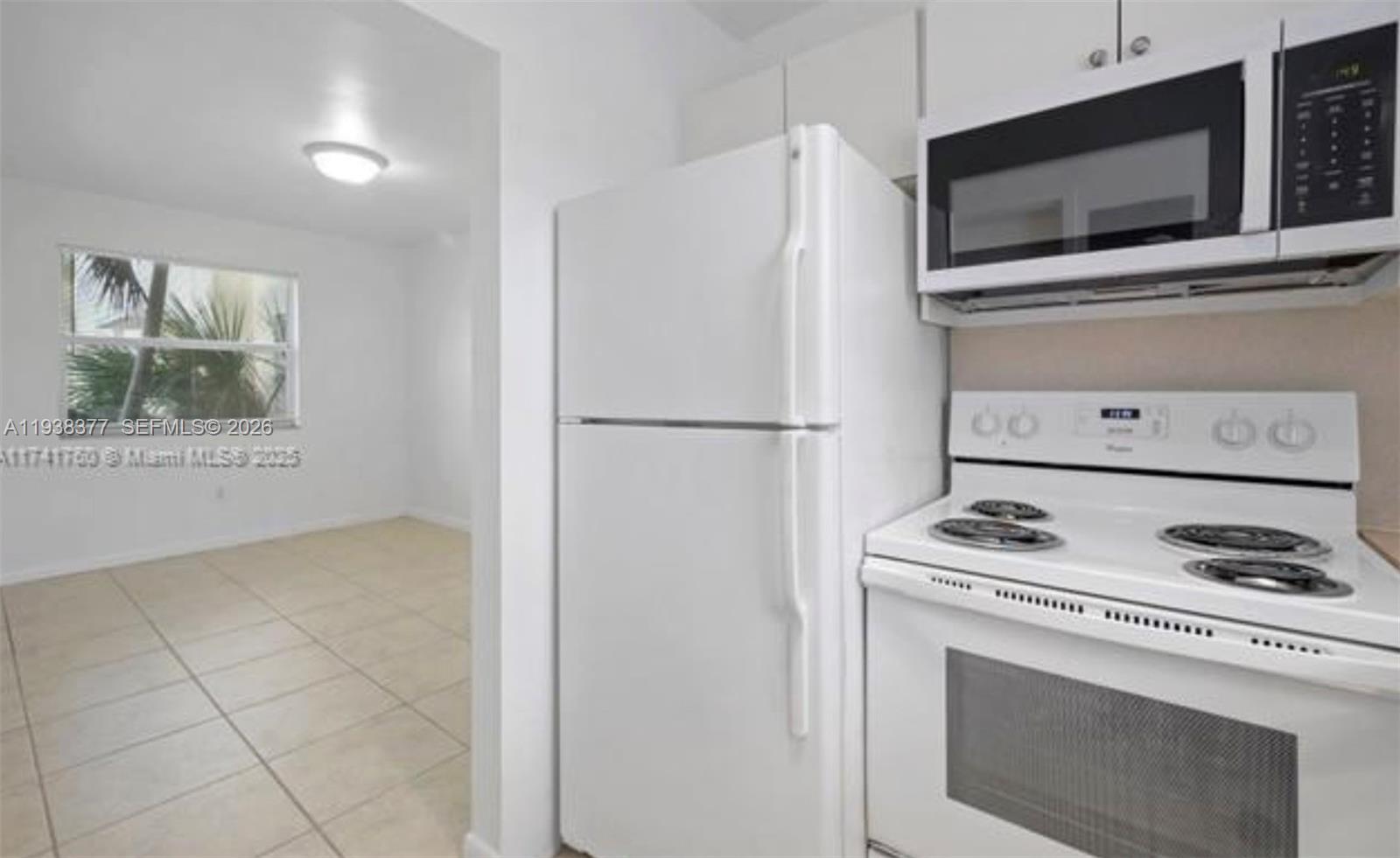 577 Northeast 82nd Street, Unit 14 Miami, FL 33138 - Photo 6 of 11 a kitchen with a stove and a microwave