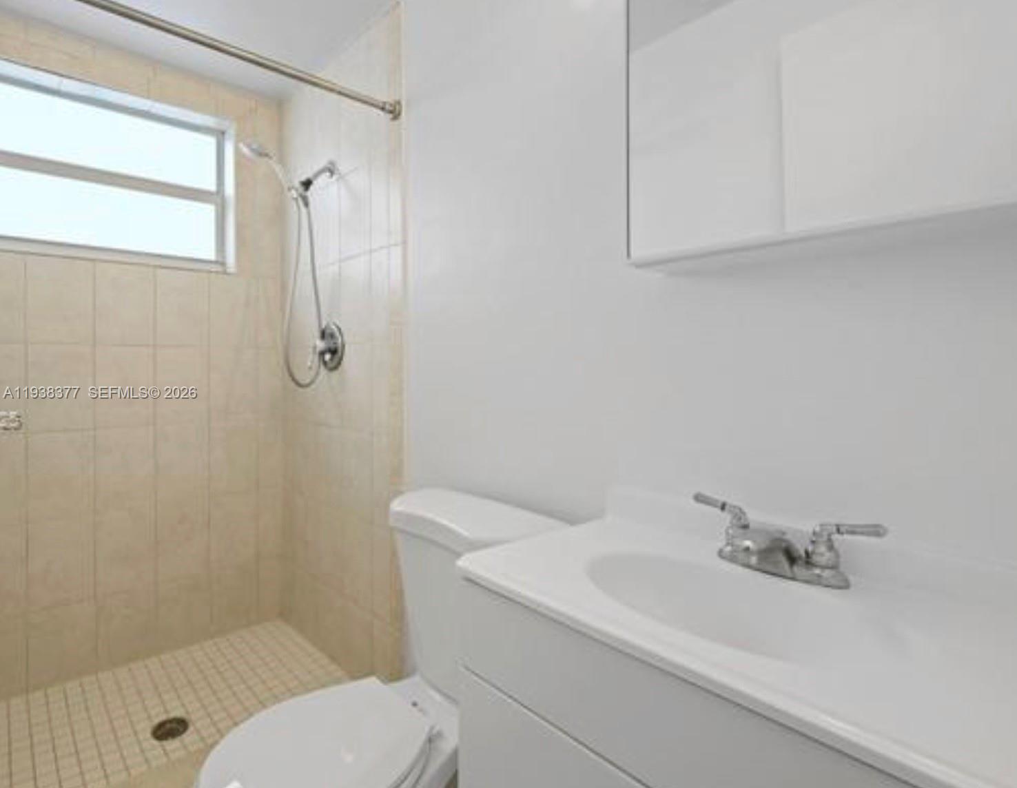 577 Northeast 82nd Street, Unit 14 Miami, FL 33138 - Photo 7 of 11 a bathroom with a sink a toilet and shower