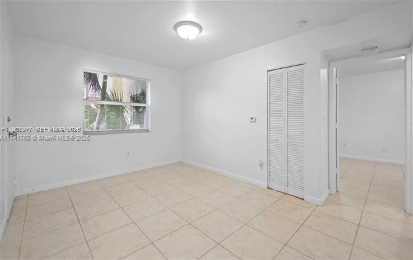 577 Northeast 82nd Street, Unit 14 Miami, FL 33138 - Photo 8 of 11 an empty room with windows