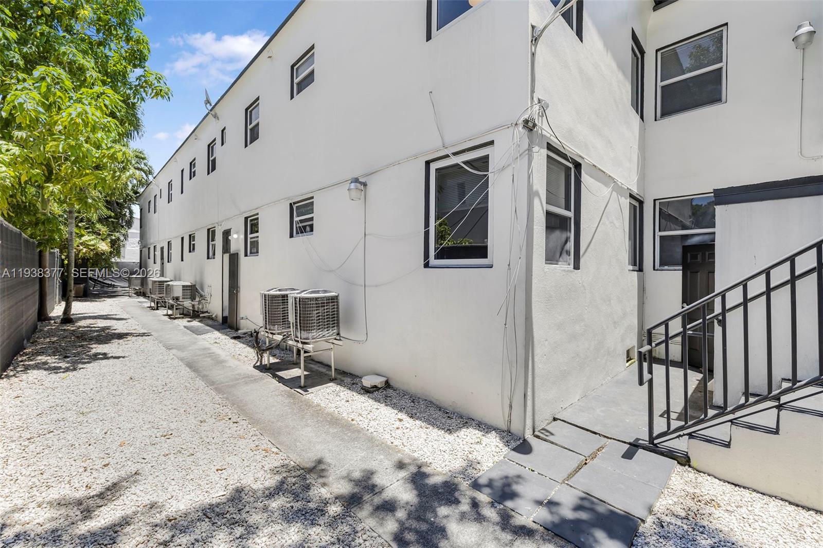 577 Northeast 82nd Street, Unit 14 Miami, FL 33138 - Photo 10 of 11 a view of a white house with large windows