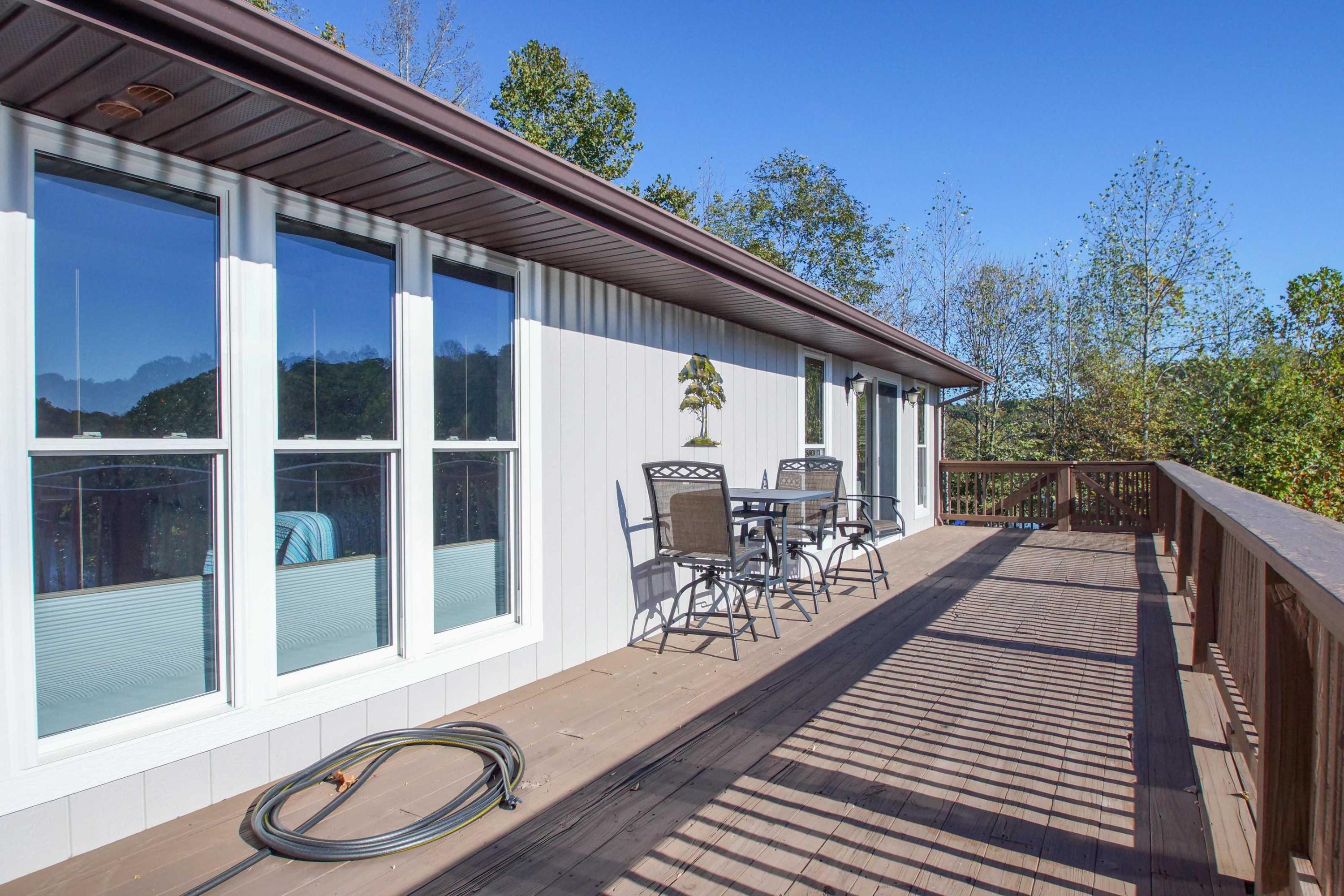 2086 Trails End Road Goodview, VA 24095 - Photo 16 of 47 a view of a balcony with chairs and wooden floor