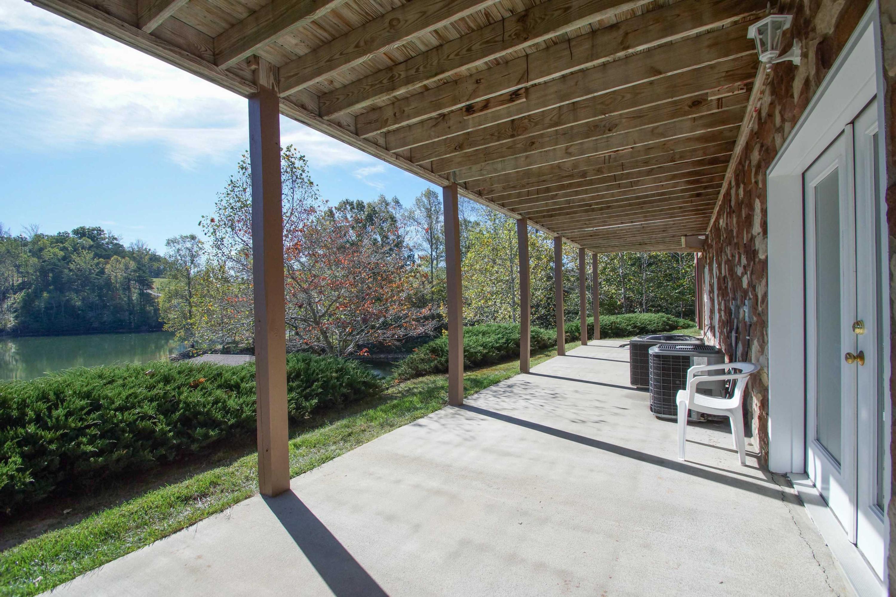 2086 Trails End Road Goodview, VA 24095 - Photo 36 of 47 a view of a patio with a table chairs and a backyard