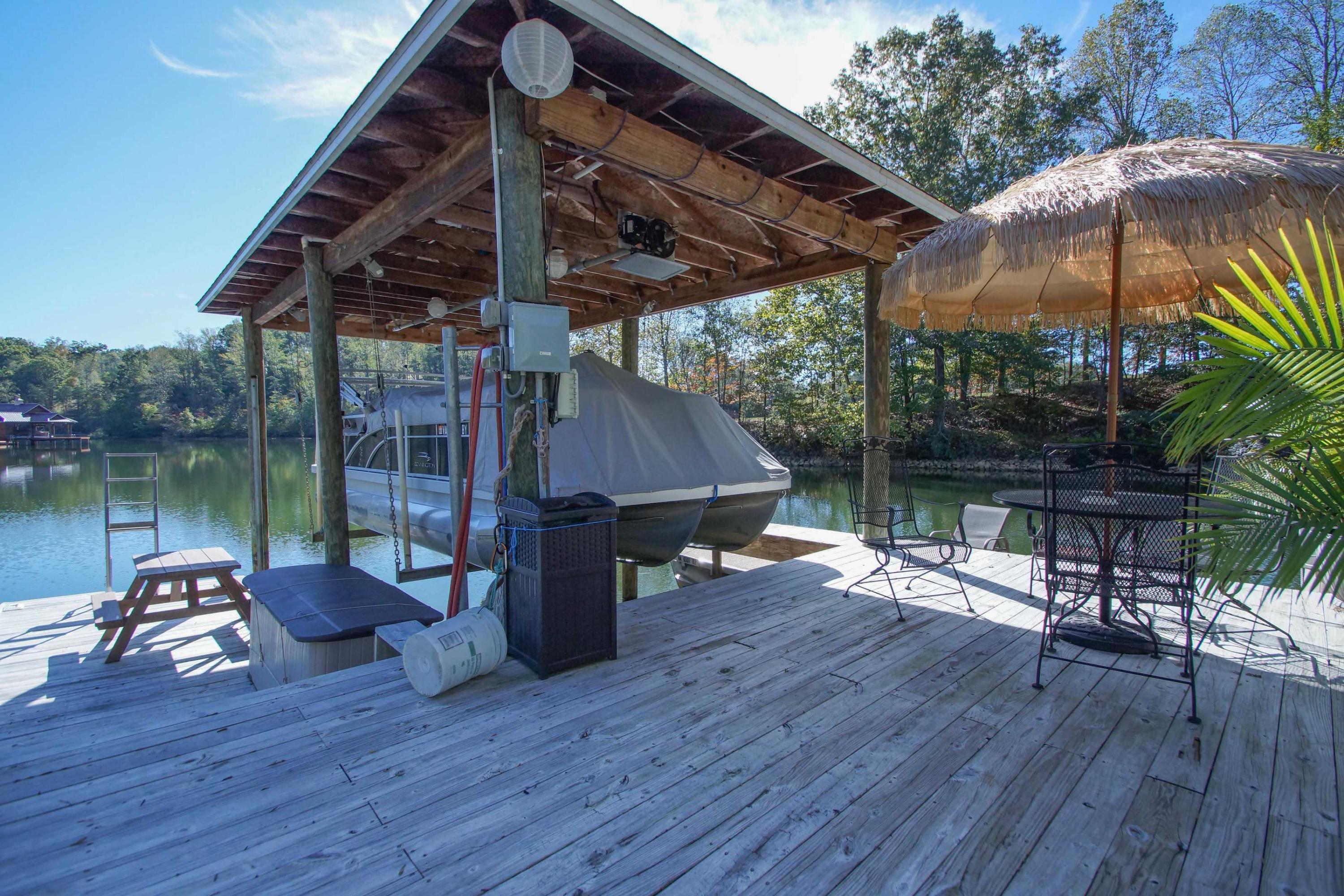 2086 Trails End Road Goodview, VA 24095 - Photo 43 of 47 a patio with wooden floor a yard a table and chairs