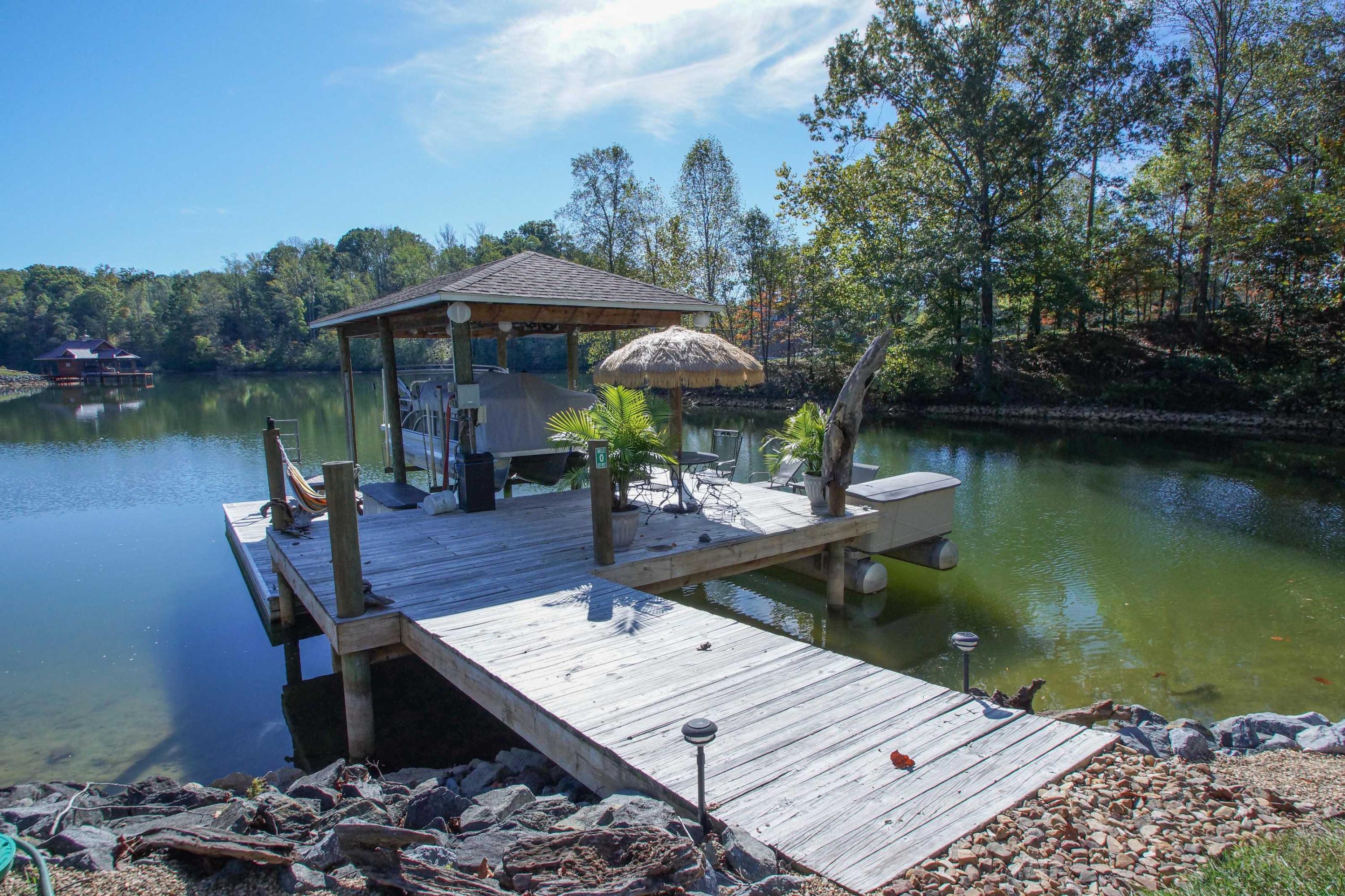 2086 Trails End Road Goodview, VA 24095 - Photo 45 of 47 a wooden bench sitting next to a lake