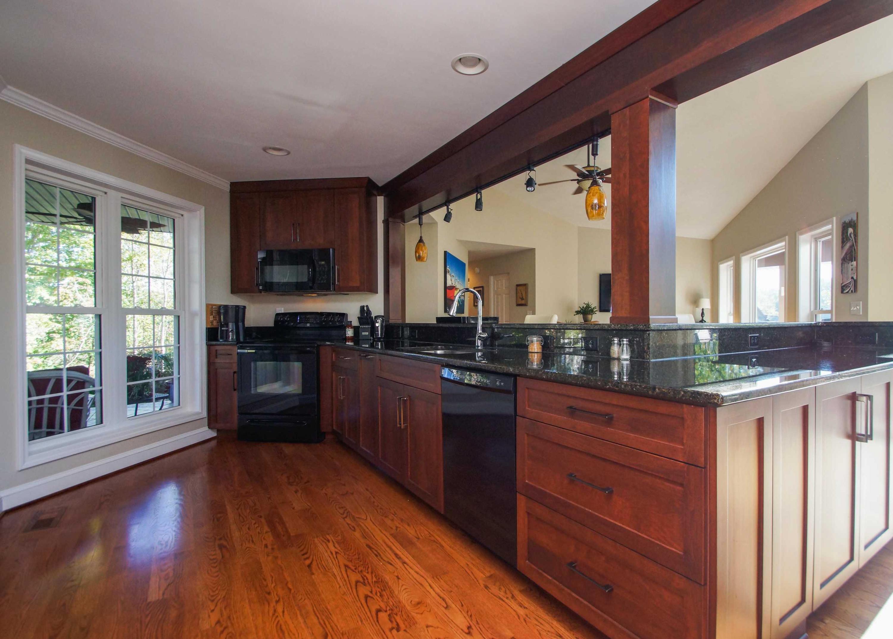 2086 Trails End Road Goodview, VA 24095 - Photo 8 of 47 a kitchen with stainless steel appliances granite countertop a stove a sink a refrigerator and a wooden cabinets