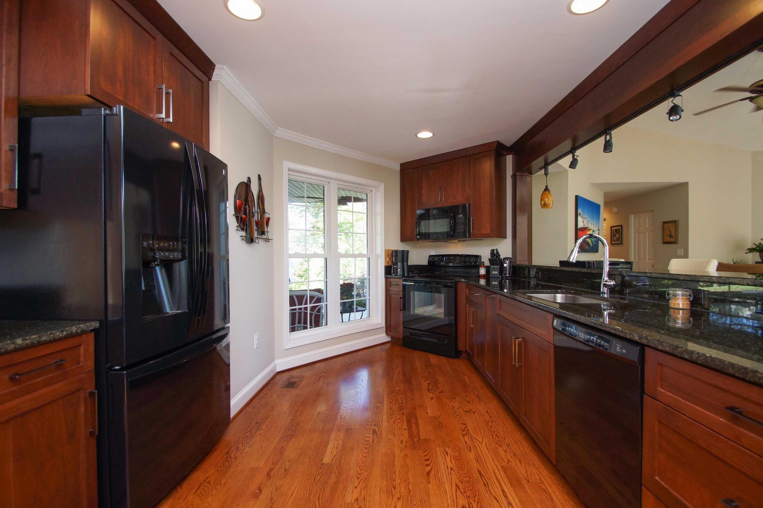 2086 Trails End Road Goodview, VA 24095 - Photo 9 of 47 a kitchen with granite countertop stainless steel appliances and wooden cabinets