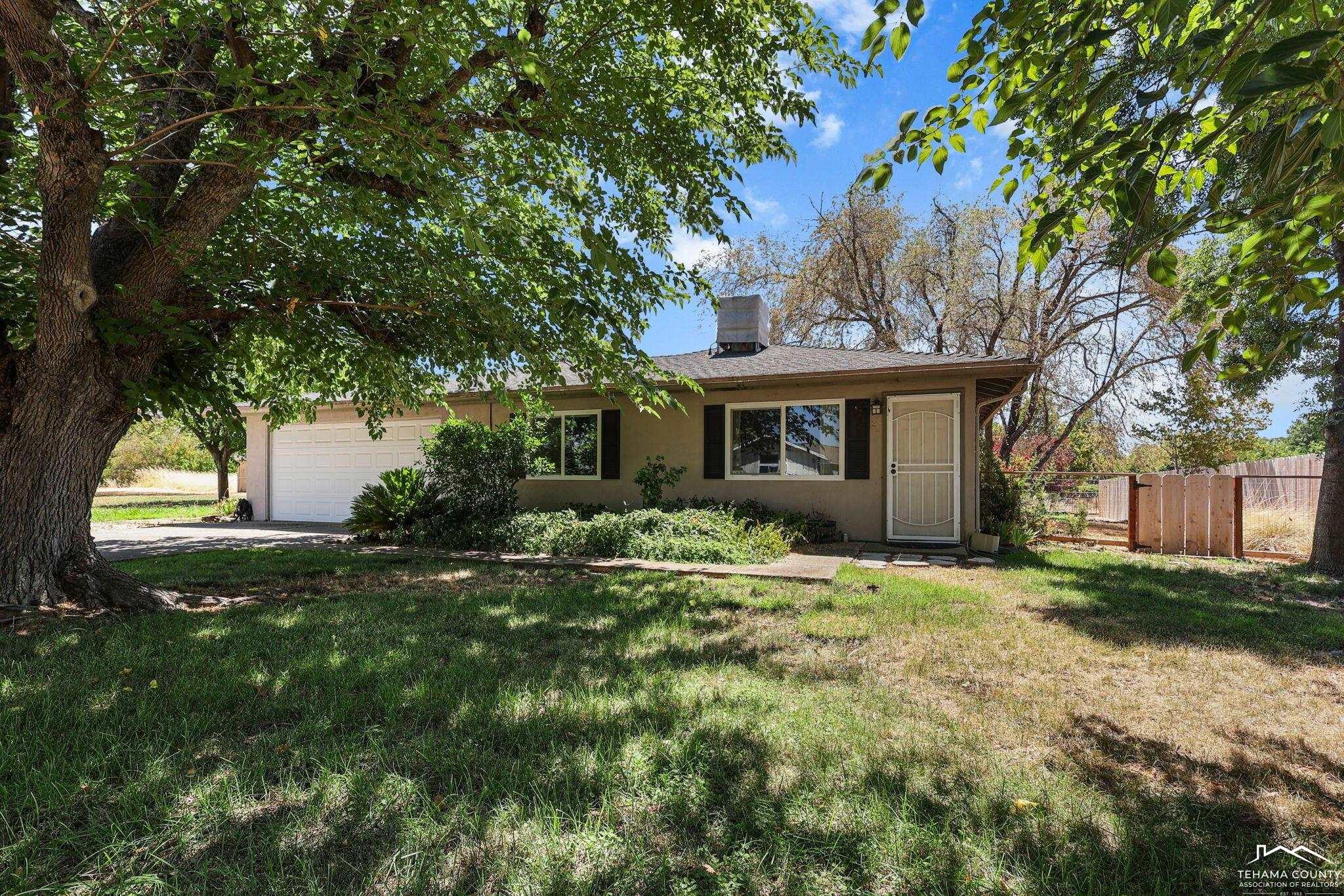 22275 Brent Road Red Bluff, CA 96080 - Photo 1 of 47 a front view of a house with a yard and garage