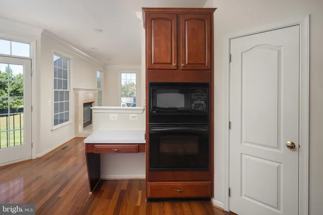 a kitchen with granite countertop white cabinets and stainless steel appliances