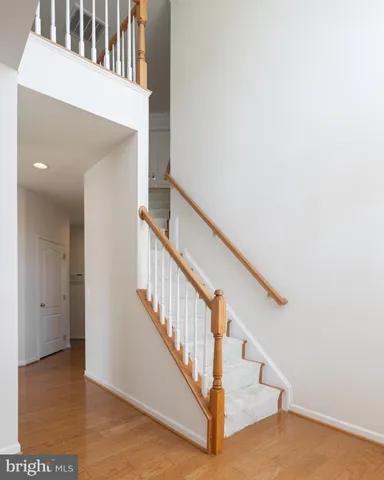 a view of staircase with white walls and a window