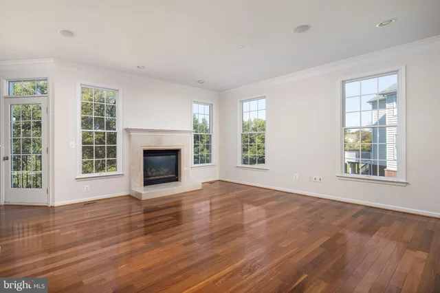 an empty room with wooden floor and a window