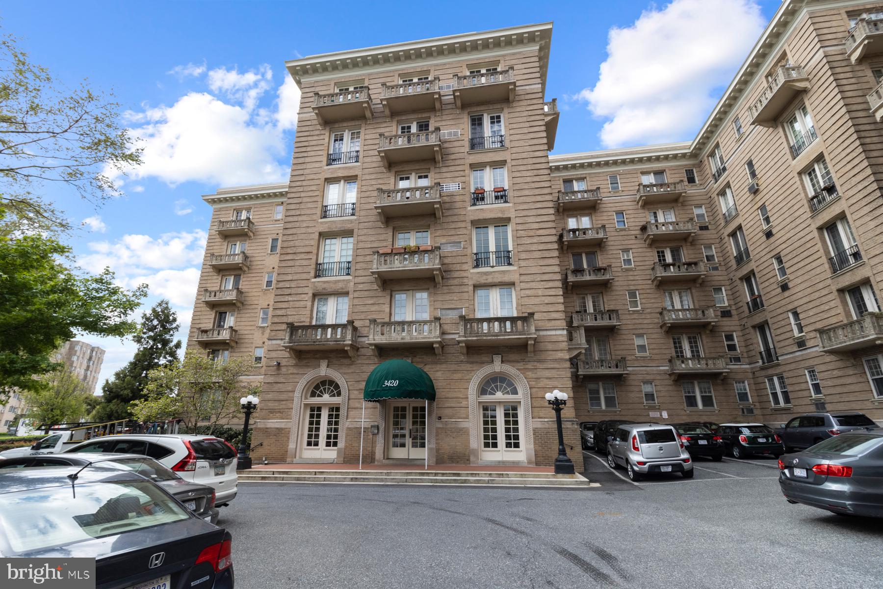 a couple of cars parked in front of a building