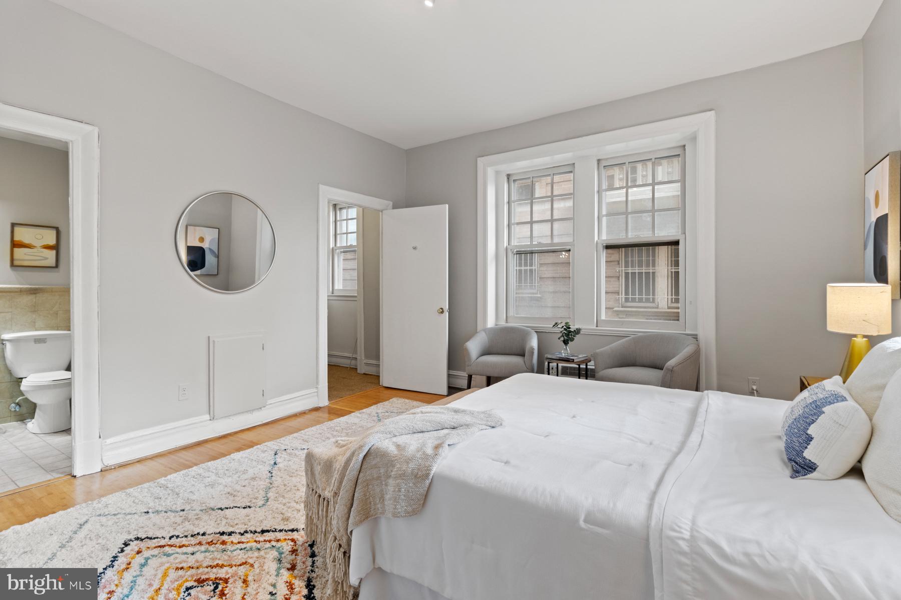 3420 16th Street Northwest, Unit 101 Washington, DC 20010 - Photo 17 of 29 a bedroom with a bed lamp and a large window