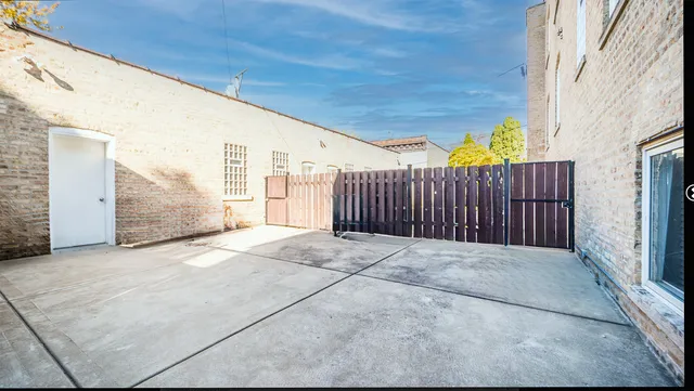 a view of backyard with patio