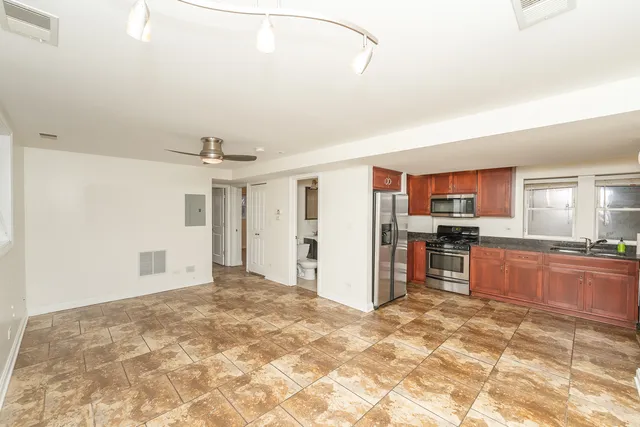 a view of a kitchen with refrigerator and a sink