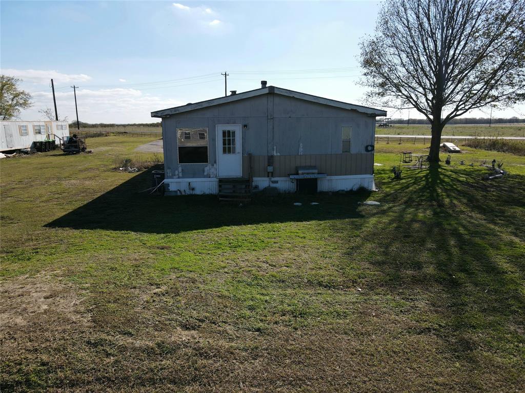 16531 Farm To Market 455 Pilot Point, TX 76258 - Photo 20 of 37 a front view of house with yard and trees