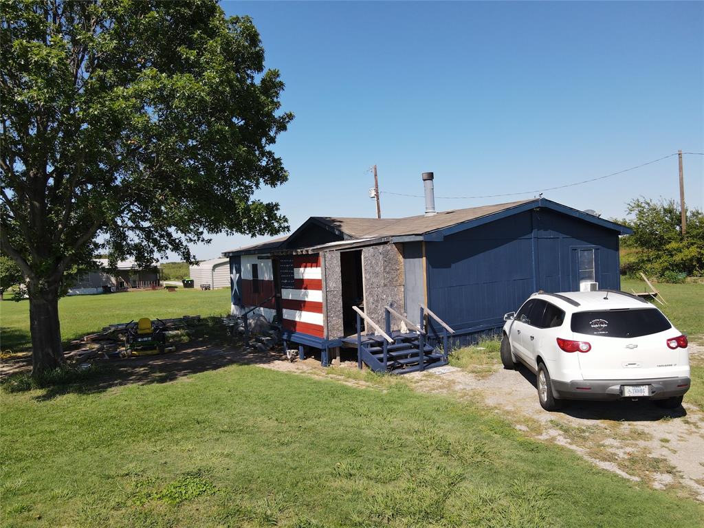 16531 Farm To Market 455 Pilot Point, TX 76258 - Photo 4 of 37 a car parked in front of a house with yard