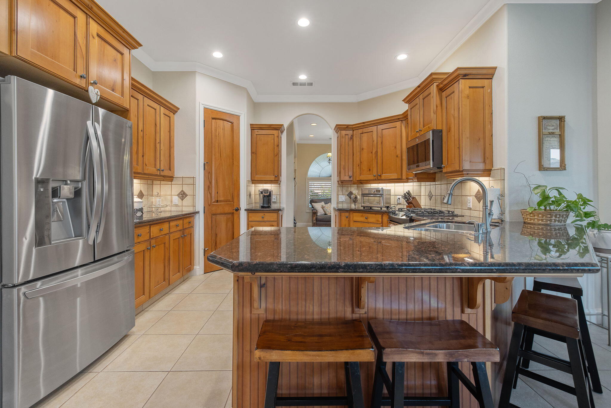 729 St Thomas Court Exeter, CA 93221 - Photo 20 of 66 a kitchen with stainless steel appliances granite countertop a dining table chairs sink and refrigerator