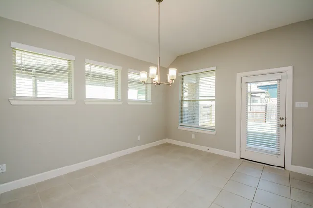 a kitchen with stainless steel appliances granite countertop a sink stove and white cabinets with wooden floor