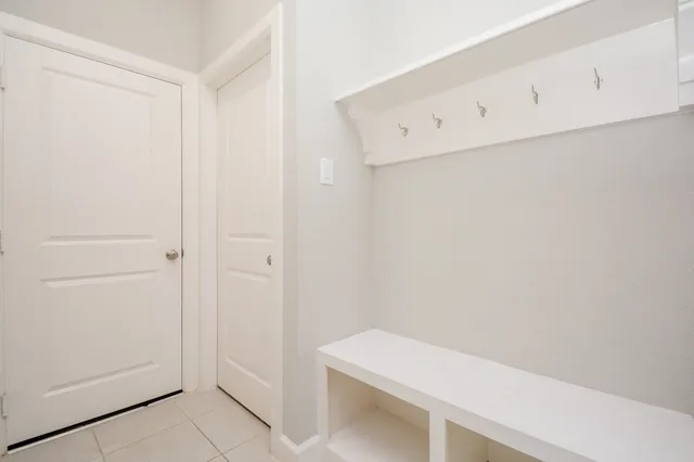 a bedroom with a large bed and a chandelier fan