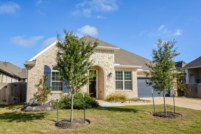a front view of a house with a yard
