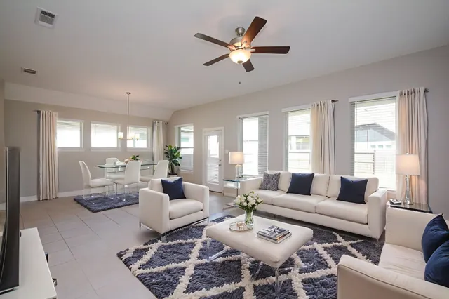 a living room with furniture and windows