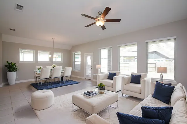an empty room with closet and a ceiling fan