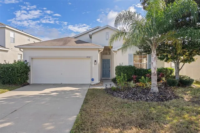 a view of a house with a yard and garage