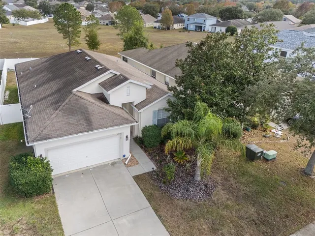an aerial view of a house with a yard