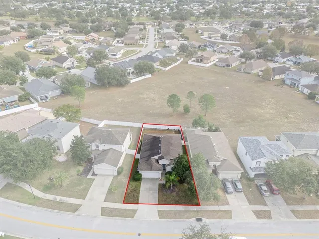 an aerial view of a house with a yard