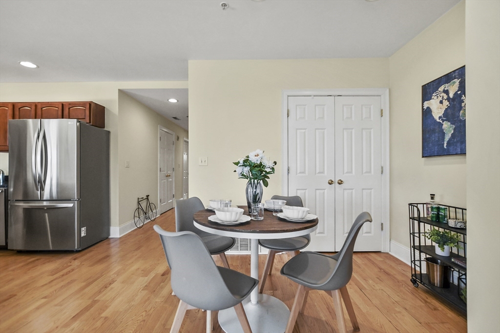 1306 Columbia Road, Unit 3E Boston, MA 02127 - Photo 15 of 40 a view of a dining room with furniture and wooden floor