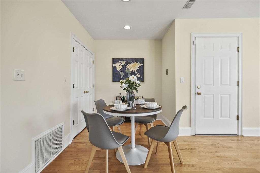 1306 Columbia Road, Unit 3E Boston, MA 02127 - Photo 17 of 40 a dining room with furniture and wooden floor