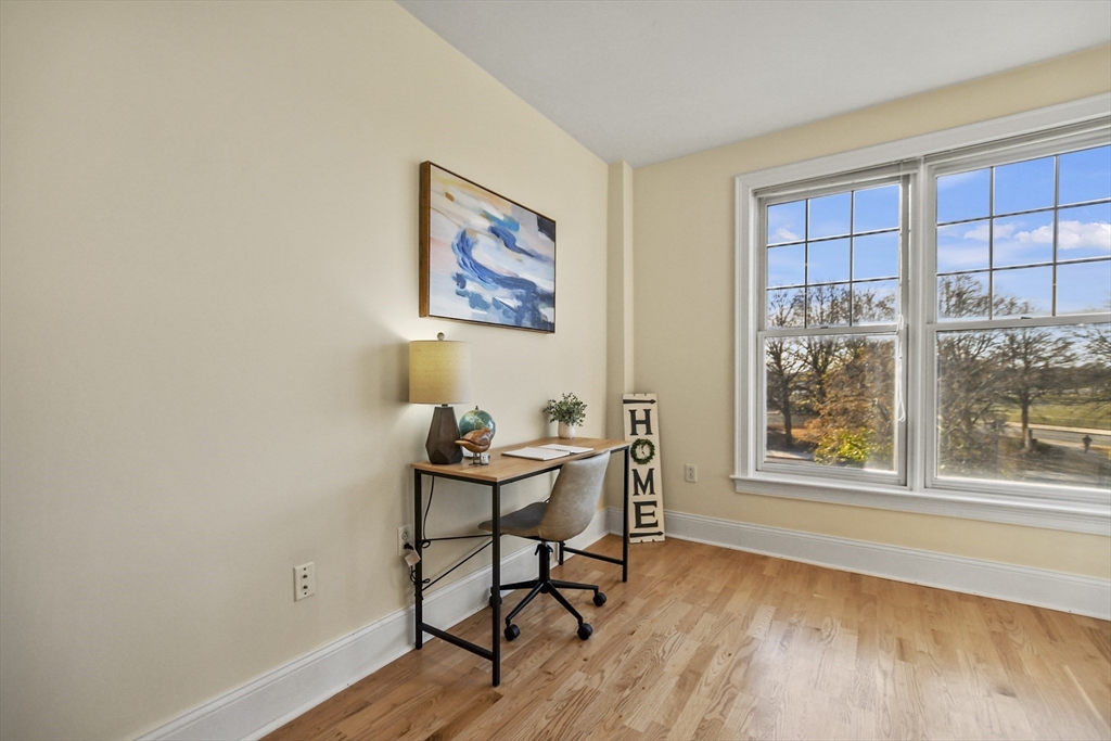 1306 Columbia Road, Unit 3E Boston, MA 02127 - Photo 18 of 40 a view of a workspace with wooden floor and a window