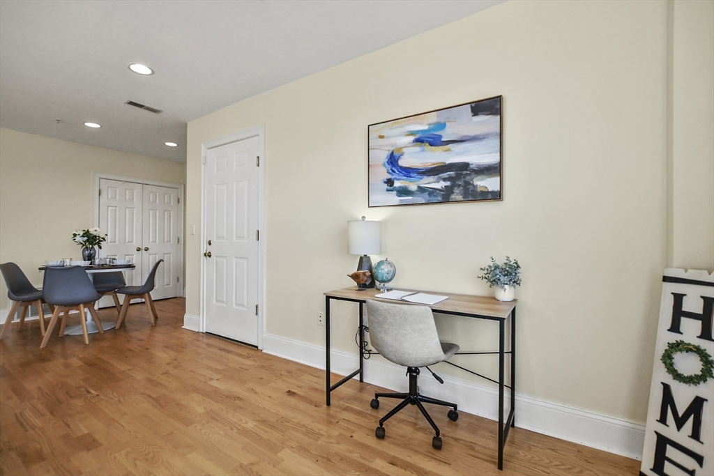 1306 Columbia Road, Unit 3E Boston, MA 02127 - Photo 19 of 40 a workspace room with furniture and wooden floor