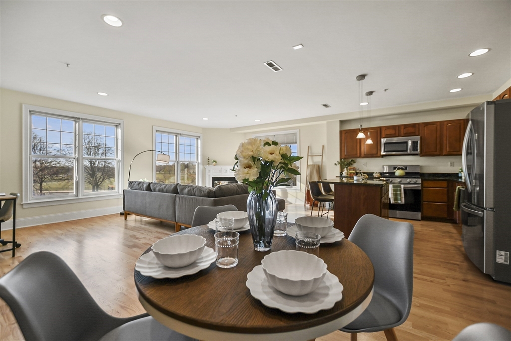 1306 Columbia Road, Unit 3E Boston, MA 02127 - Photo 2 of 40 a dining room with furniture a wooden floor and kitchen view