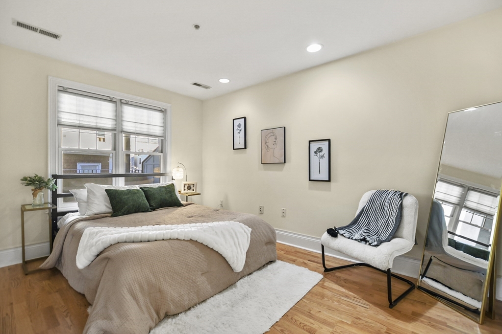 1306 Columbia Road, Unit 3E Boston, MA 02127 - Photo 22 of 40 a bedroom with a bed and a couch