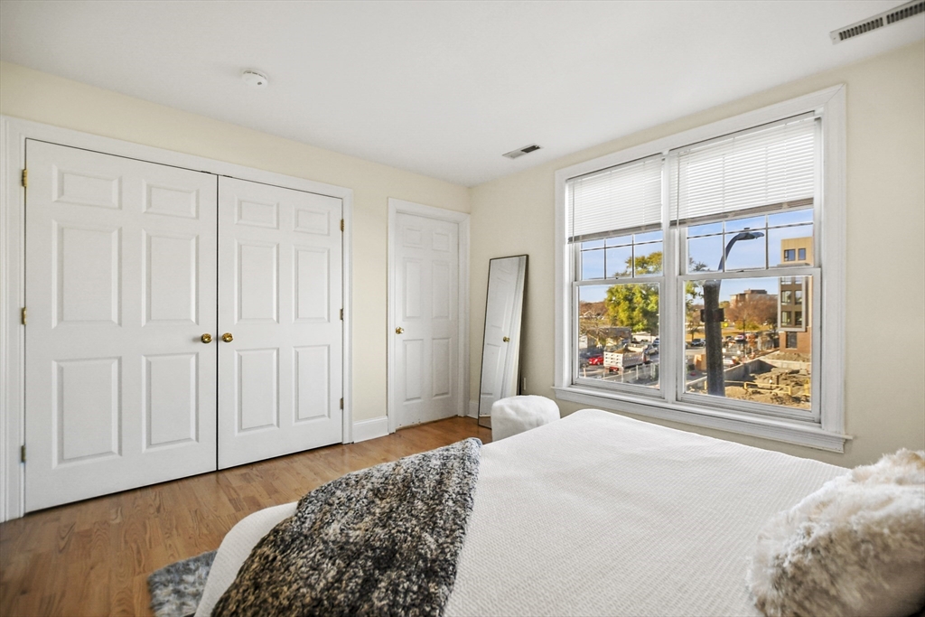 1306 Columbia Road, Unit 3E Boston, MA 02127 - Photo 23 of 40 a bedroom with a bed and a window