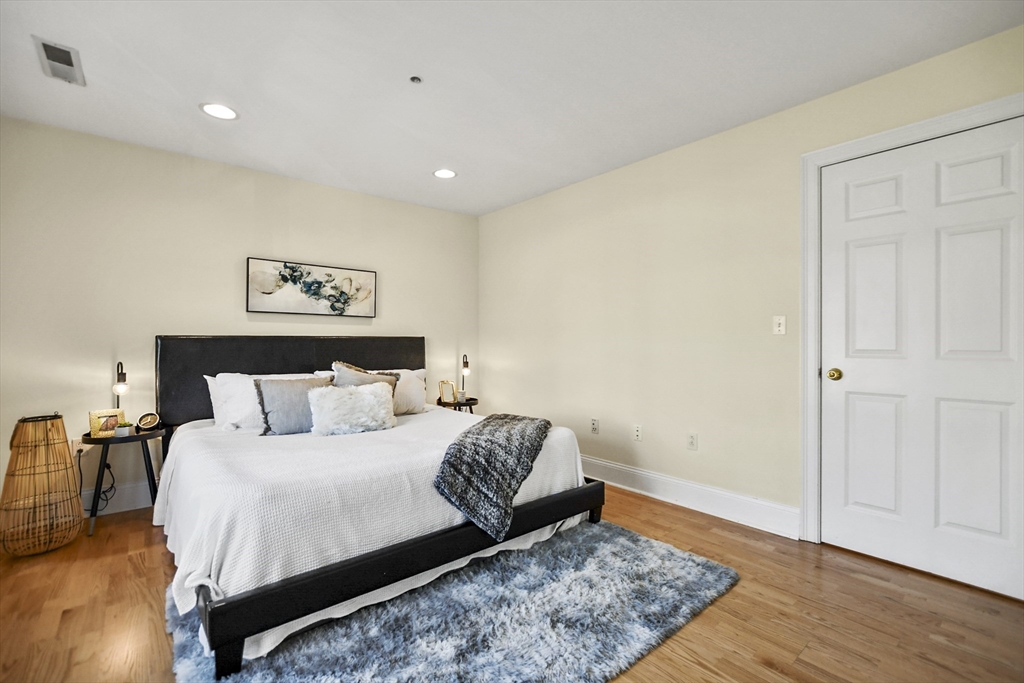 1306 Columbia Road, Unit 3E Boston, MA 02127 - Photo 25 of 40 a bedroom with a large bed and a rug