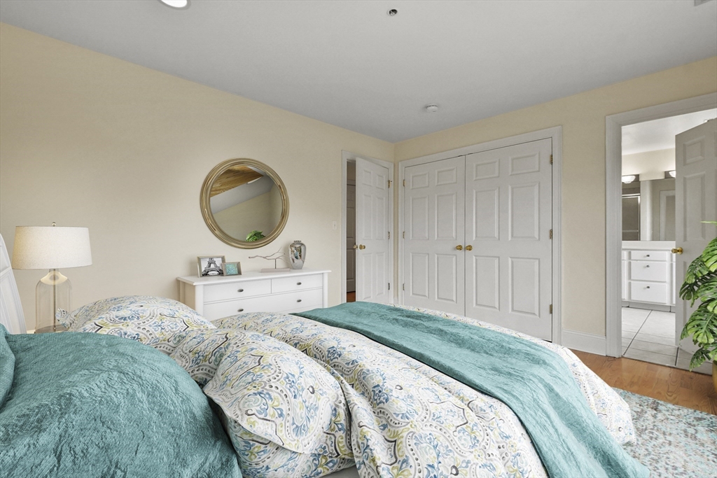 1306 Columbia Road, Unit 3E Boston, MA 02127 - Photo 29 of 40 a bedroom with a bed and a chandelier