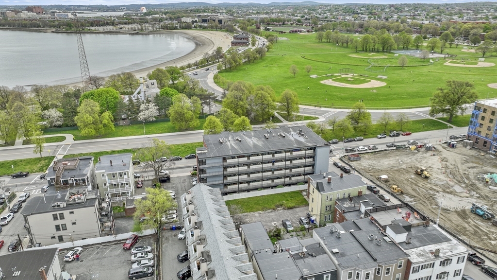 1306 Columbia Road, Unit 3E Boston, MA 02127 - Photo 38 of 40 an aerial view of a house with a garden and lake view