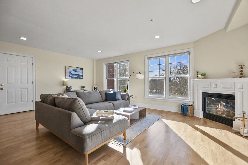1306 Columbia Road, Unit 3E Boston, MA 02127 - Photo 4 of 40 a living room with furniture and a fireplace