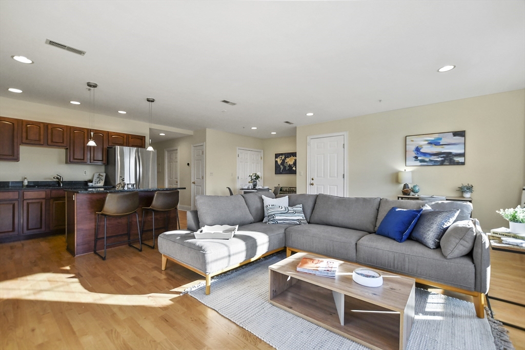 1306 Columbia Road, Unit 3E Boston, MA 02127 - Photo 5 of 40 a living room with furniture kitchen view and a table