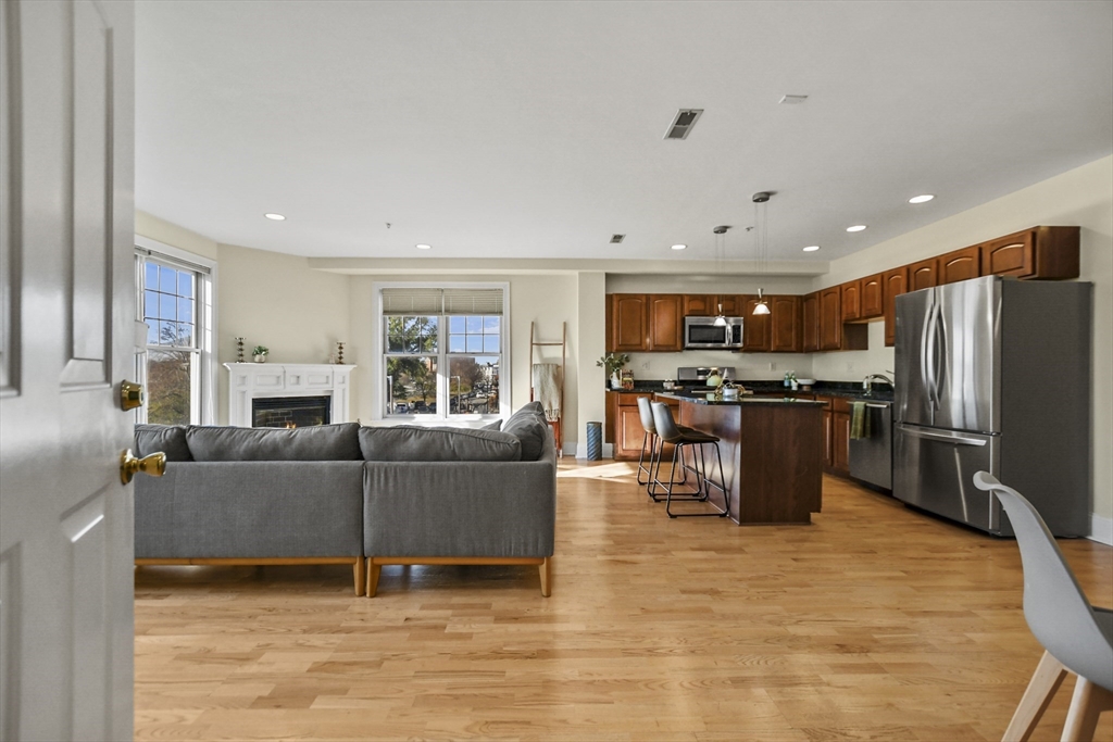 1306 Columbia Road, Unit 3E Boston, MA 02127 - Photo 6 of 40 a living room with furniture and kitchen view