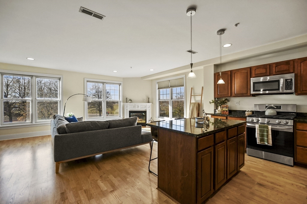 1306 Columbia Road, Unit 3E Boston, MA 02127 - Photo 7 of 40 a living room with furniture and a flat screen tv