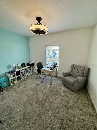 a living room with furniture and white walls