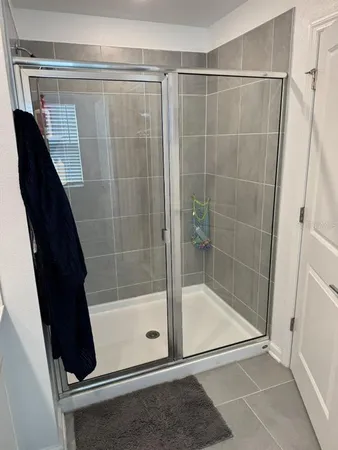 a bathroom with a shower and a sink