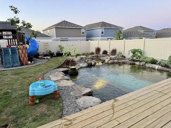 a swimming pool with outdoor seating yard and barbeque oven