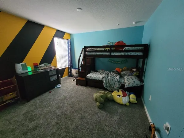 a room with toys and a baby crib